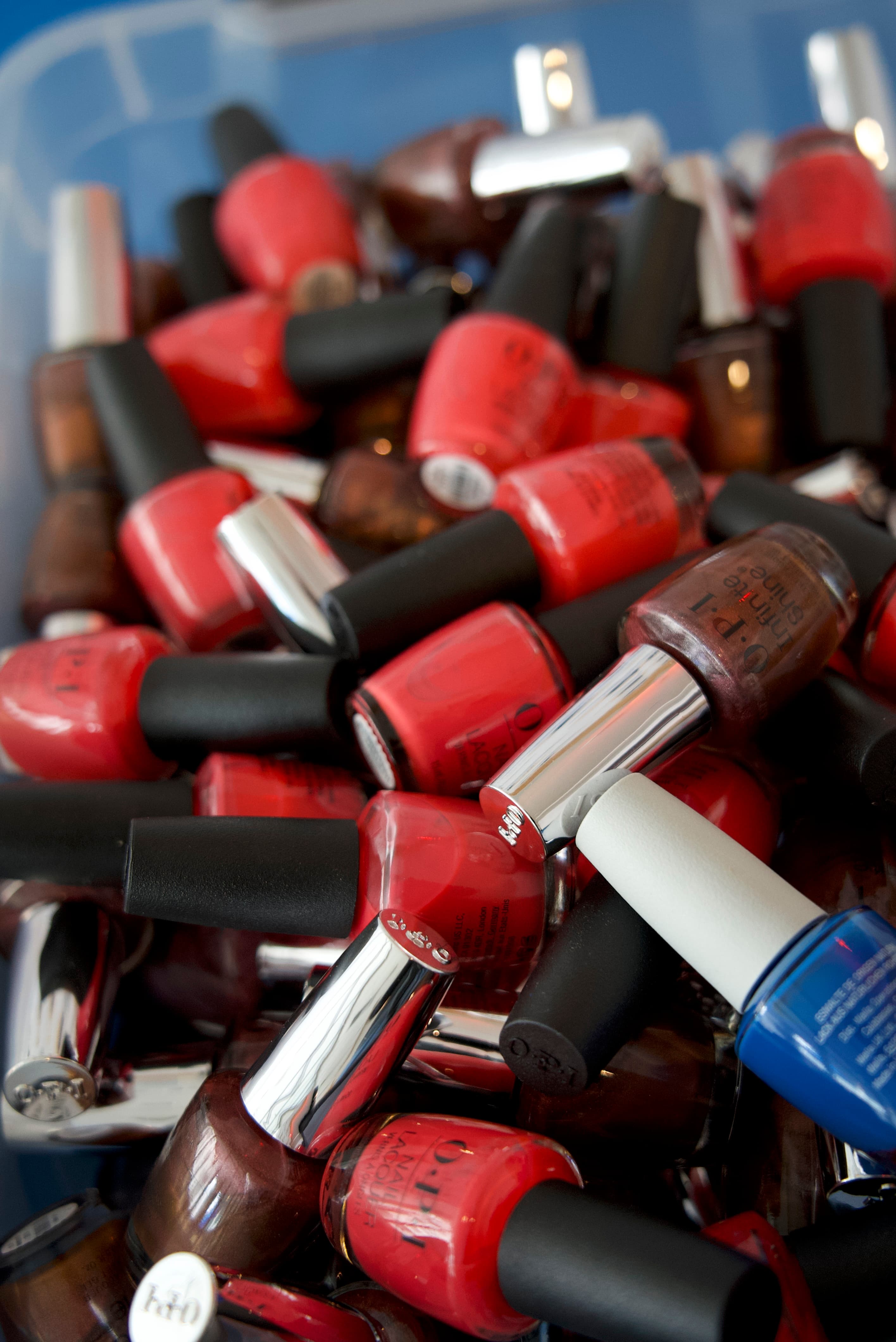 A bin of donated nail polish, sorted and ready to distribute